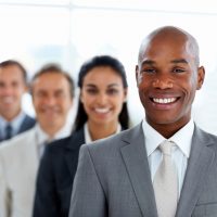 Happy African American business man with colleagues in a line